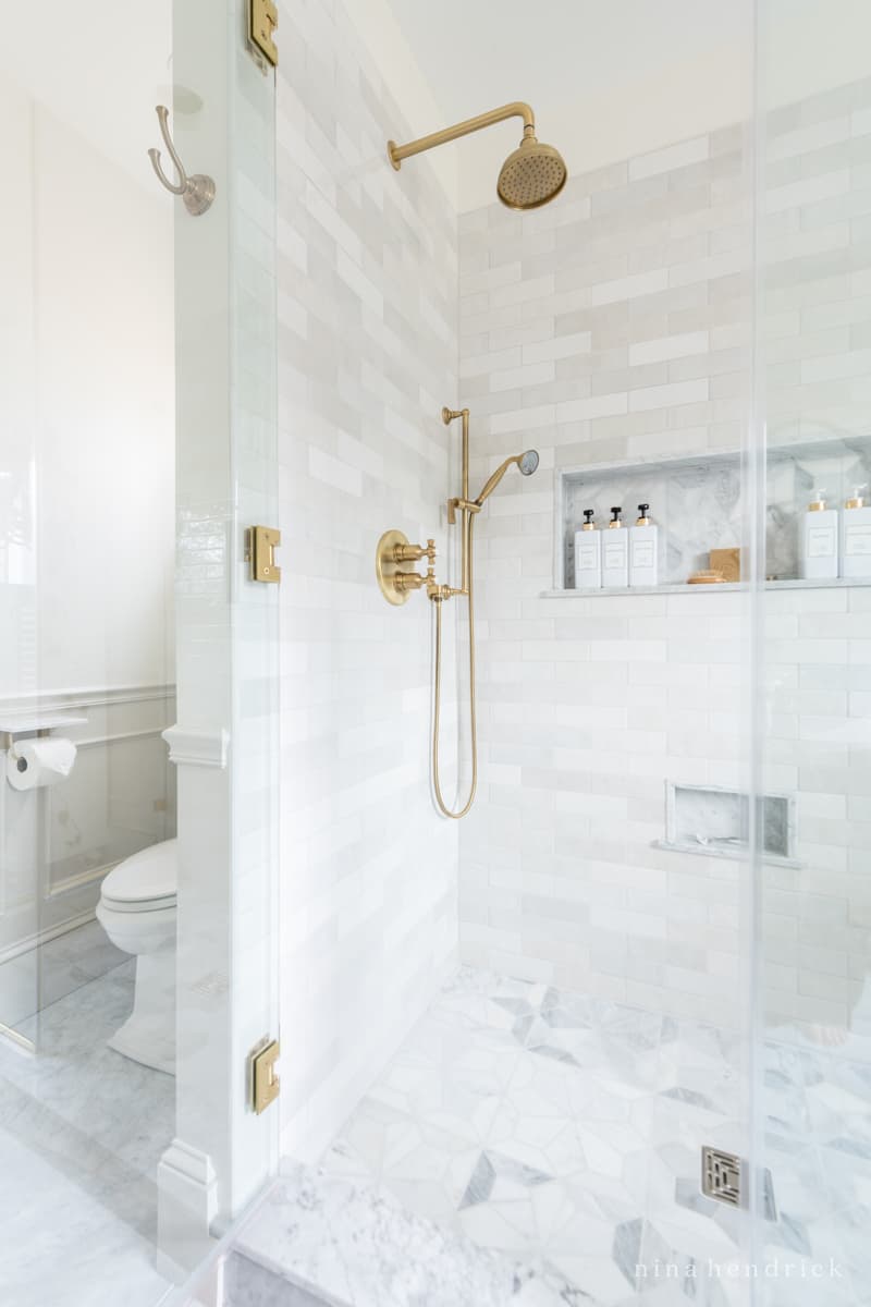 Shower with zellige tile and brass shower system and glass door hardware