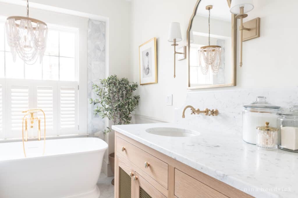 Bathroom remodel with marble countertops, tile, and bathtub