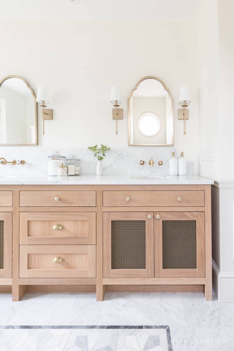White Oak bathroom vanity with marble counter and brass hardware