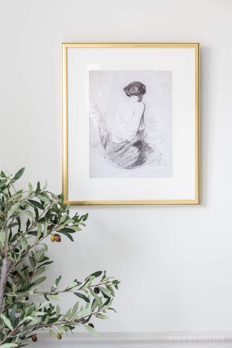 Vintage bathroom artwork featuring a sketch of a woman 