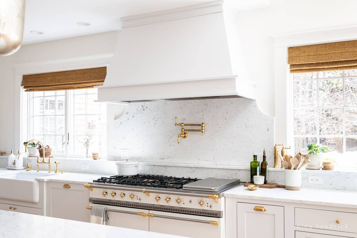 Scalloped marble slab backsplash and marble window ledge detail