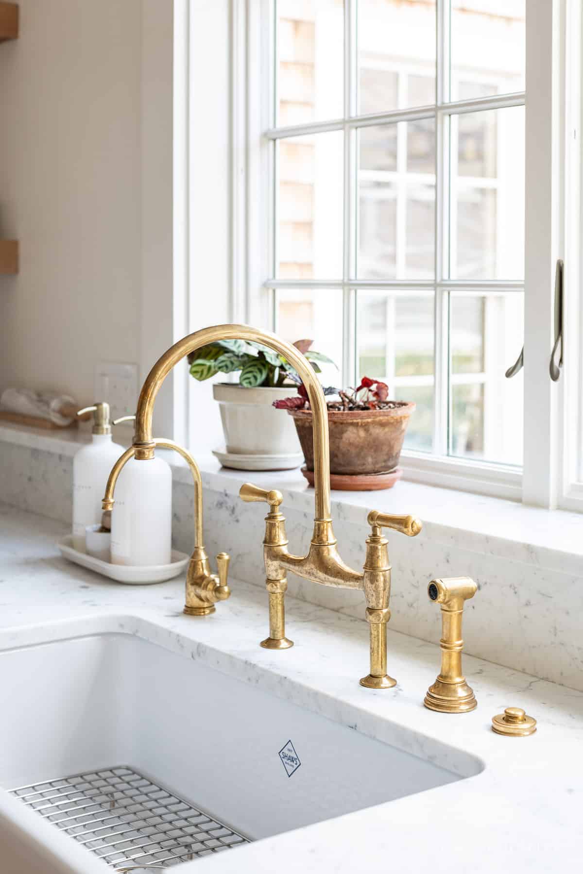 Unlacquered brass faucet and a Shaws sink