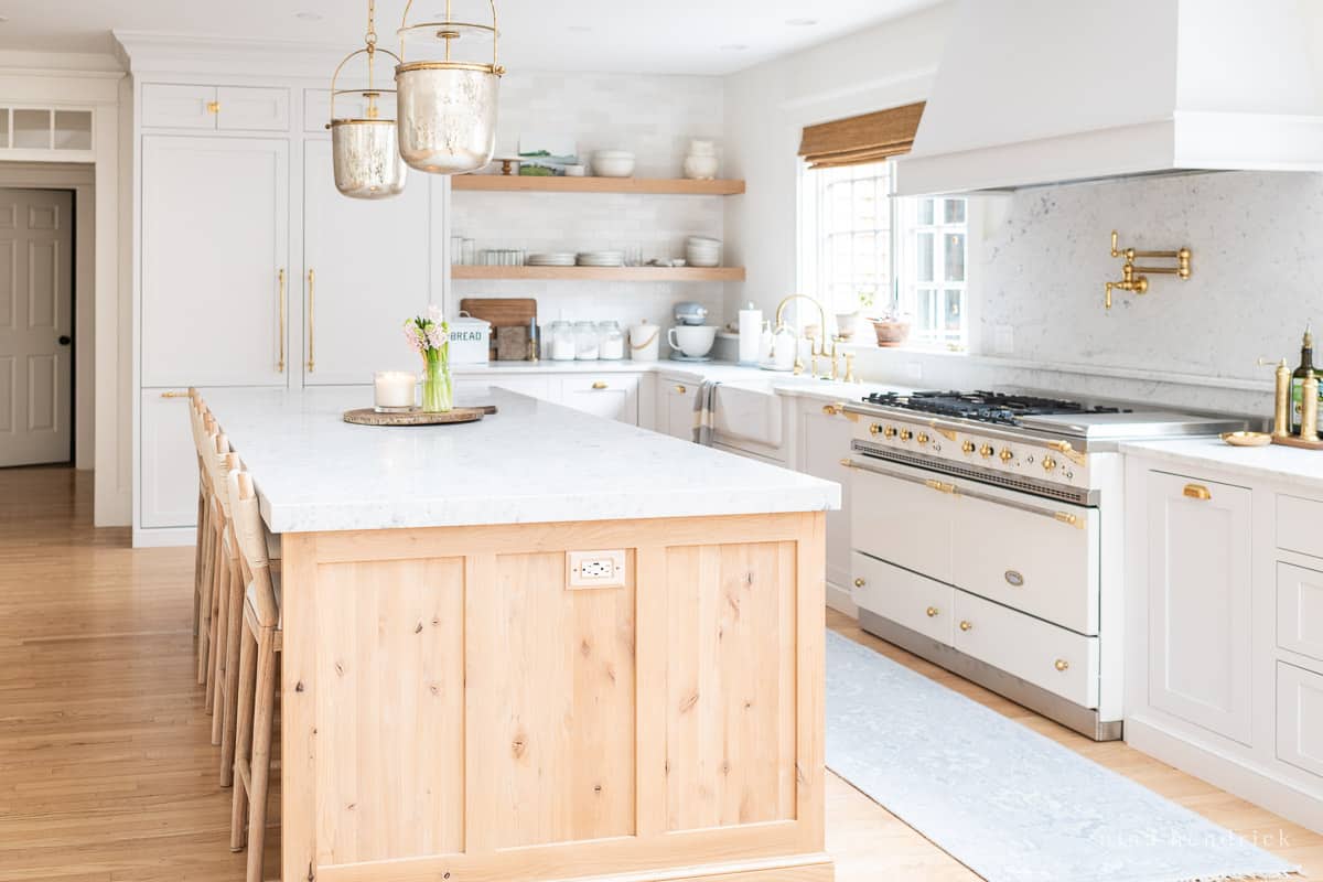 Timeless kitchen with a warm wood island and pale gray cabinets