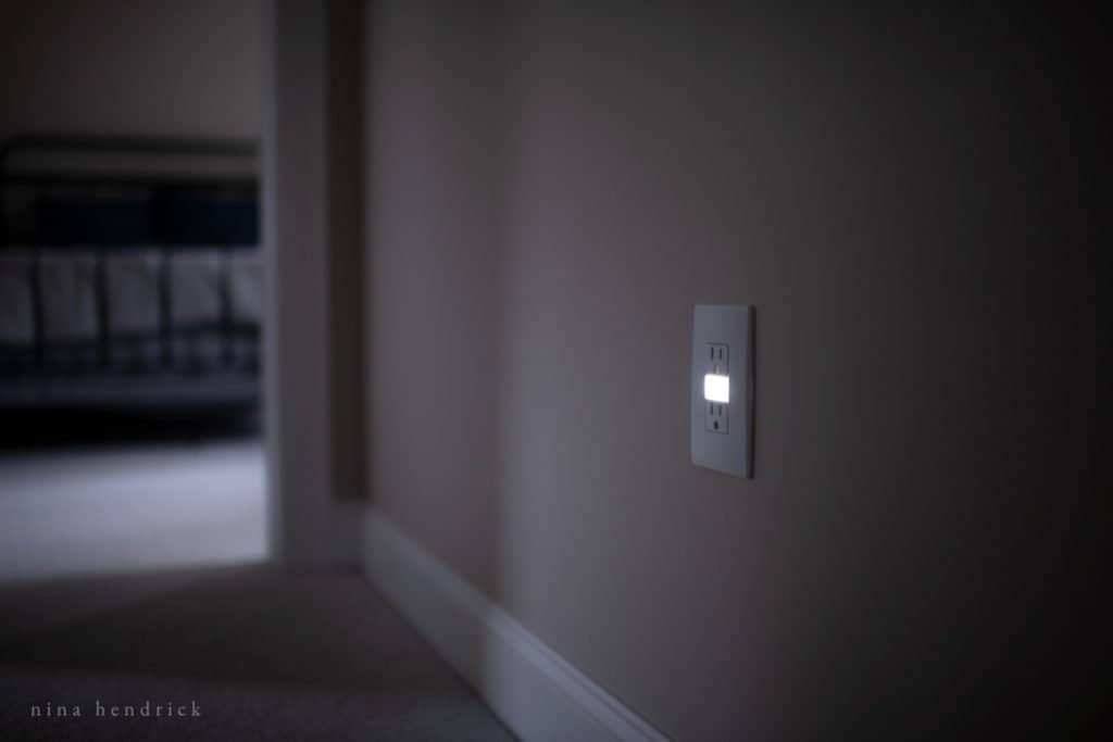 Outlet with nightlight in dark hallway