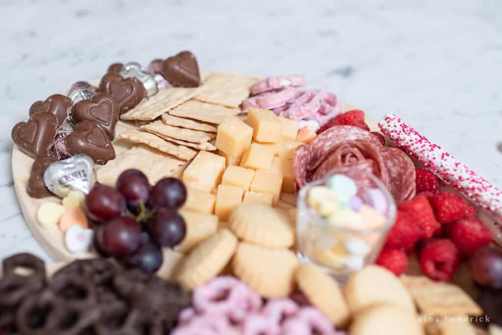 Milk chocolate heart candies and cheese on a snack platter