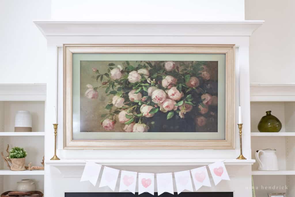 FrameTV with vintage floral art and a free printable banner for Valentine's Day on the mantel