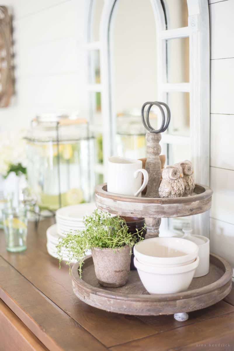 Tiered wooden tray with small bowls and owl salt and pepper shakers