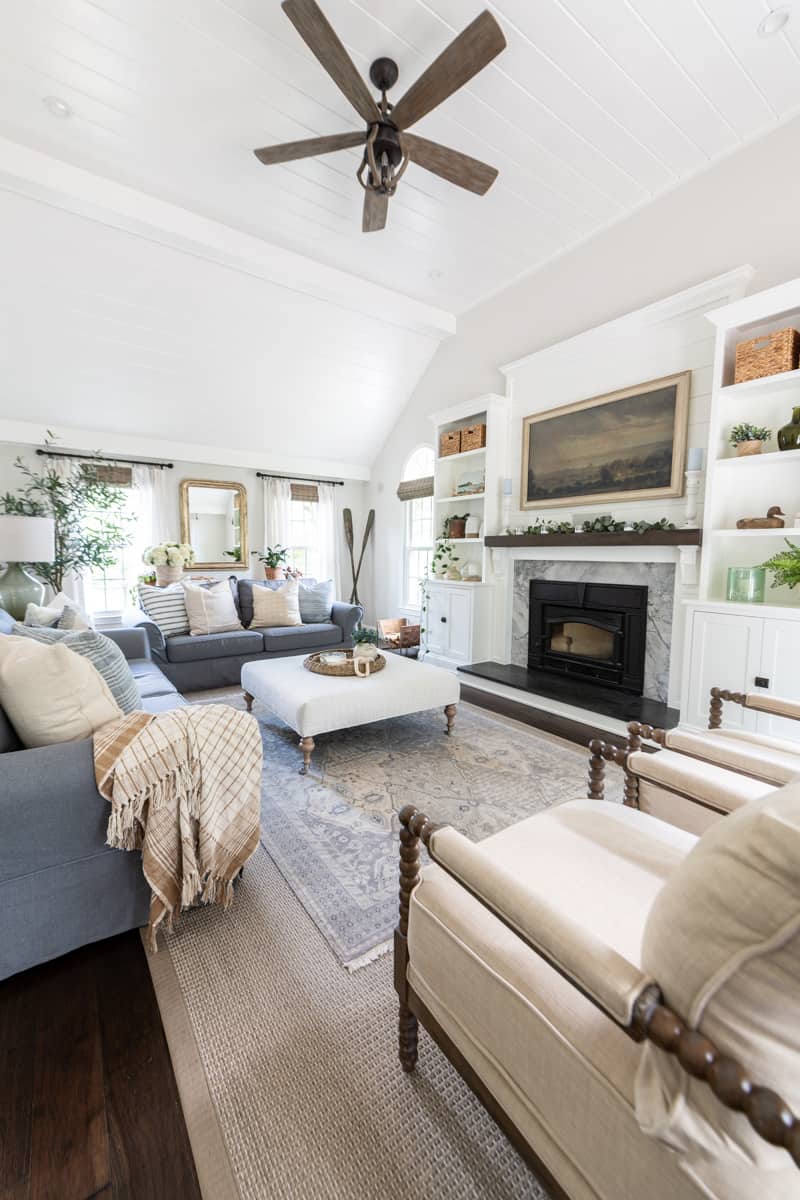 Living room with white cathedral tongue-and-groove ceiling wall molding treatment