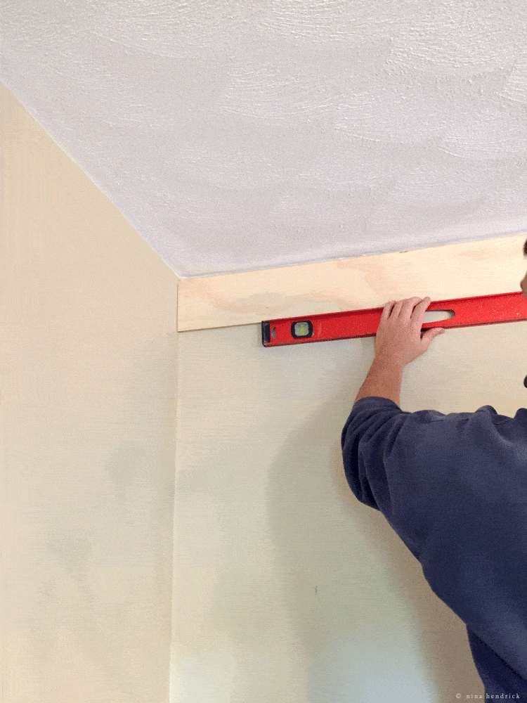 Securing planks to the wall and leveling