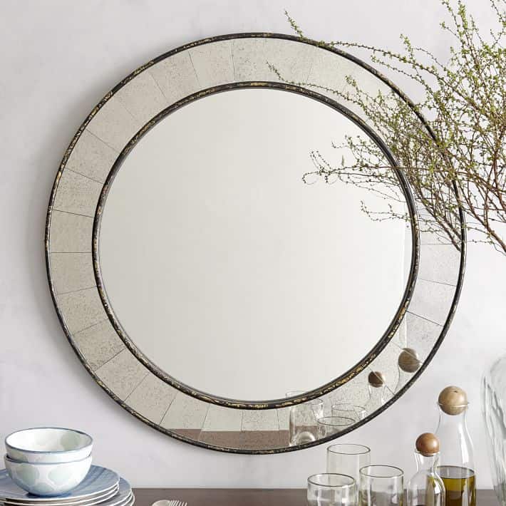 See the inspiration behind a Collected and Contrasting Dining Room Design. This room features a bold wall color, antique finishes, and a ton of texture.