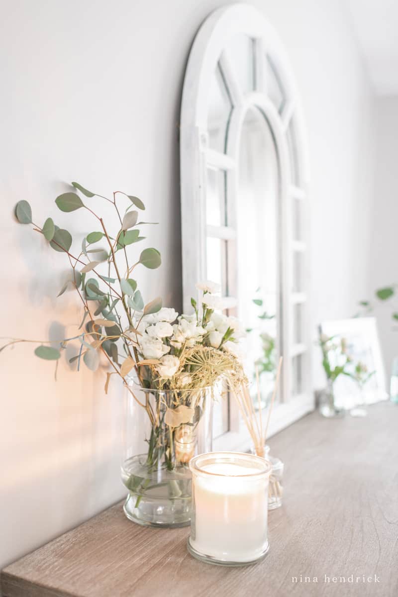 Winter decor after Christmas — grocery store candles and a new candle plus a room refreshened near the dresser mirror.