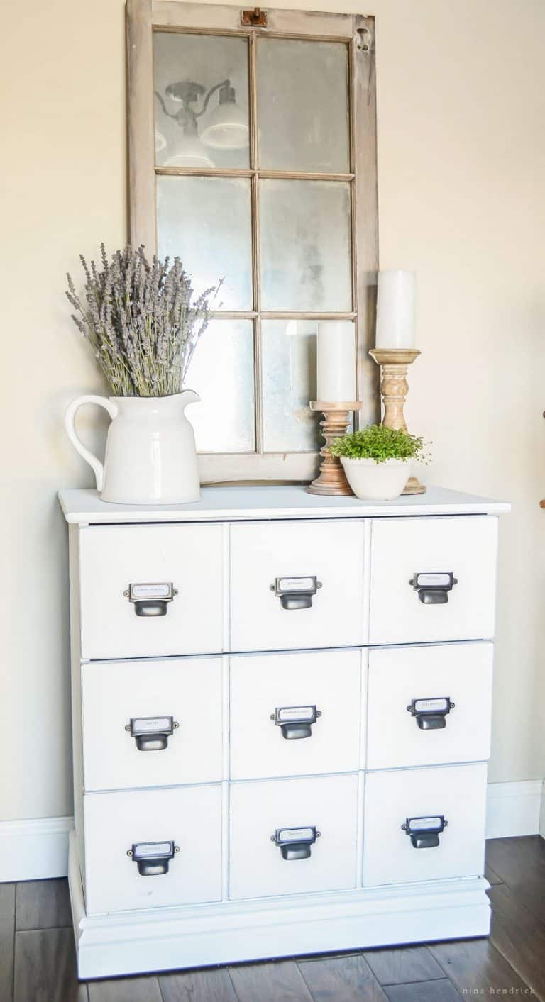 A white Ikea dresser by the window, beautifully hacked.
