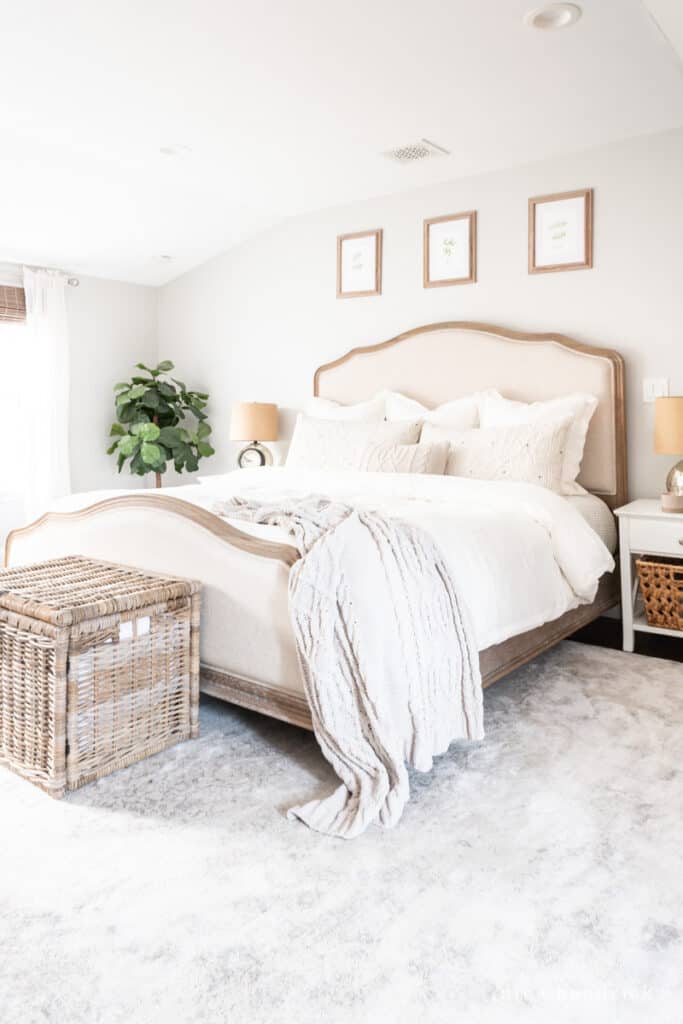 Wood and Upholstered Bed with neutral bedding in a Repose Gray bedroom