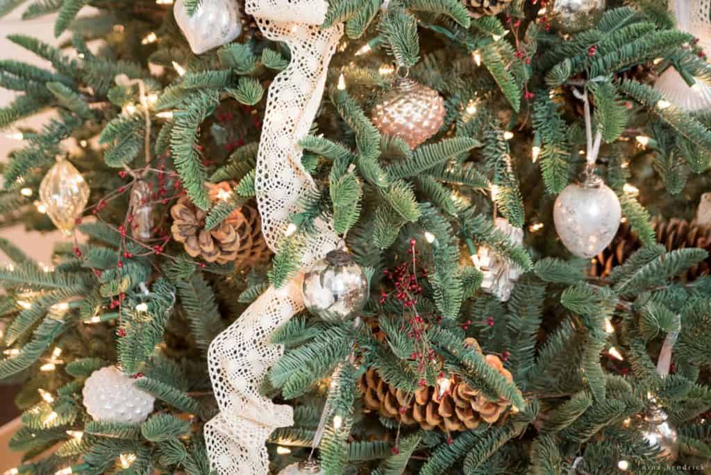 rustic red berries and vintage lace on a faux spruce for the holidays
