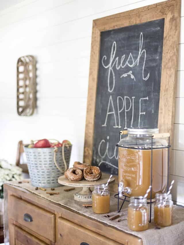 Fresh apple cider bar with chalkboard sign.