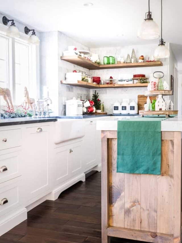 A white kitchen with green and white decorations.