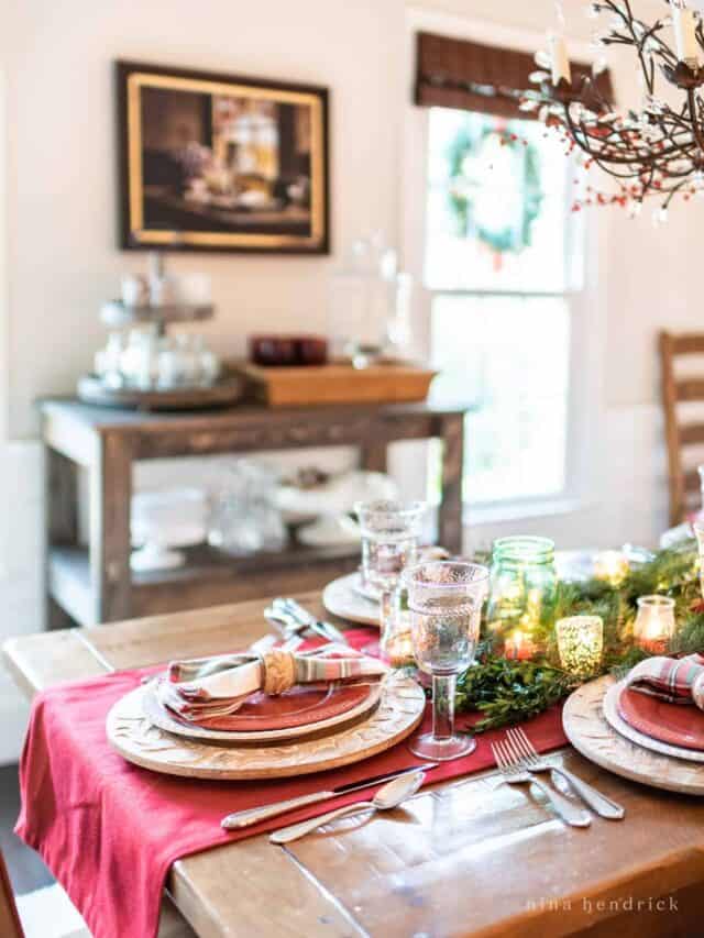 A christmas table setting in a dining room.