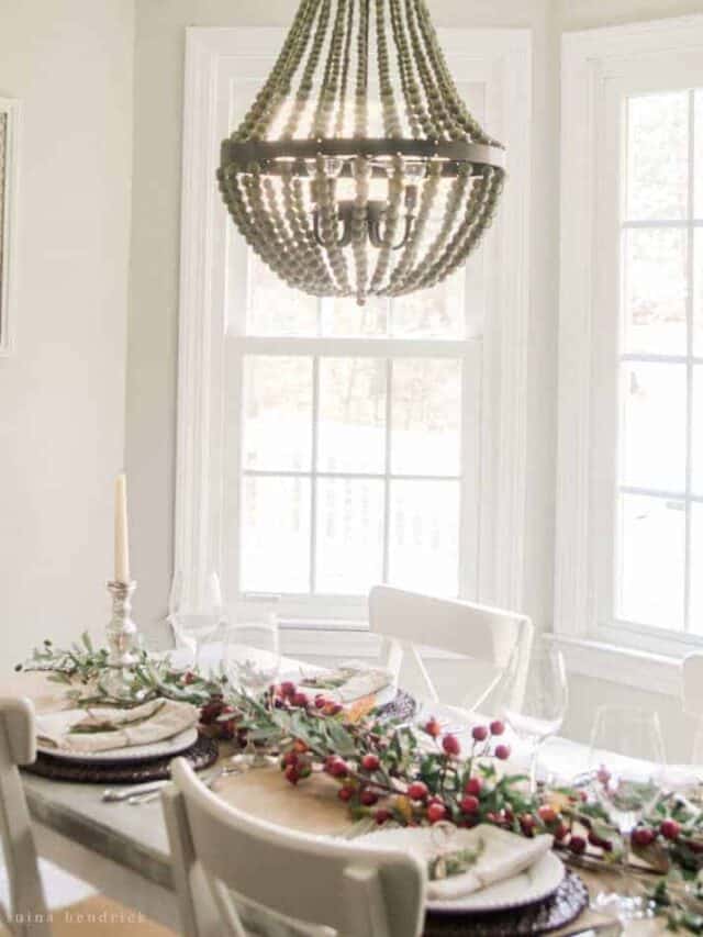 A white dining room with a chandelier.