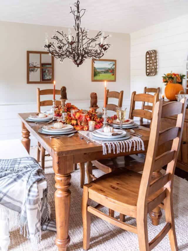 A dining room with a wooden table and chairs.