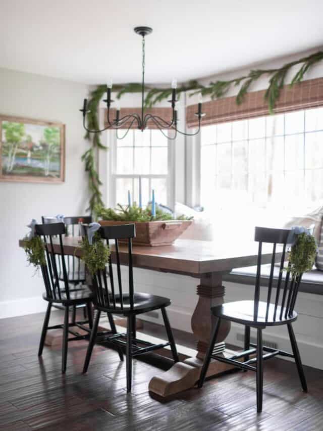 A dining room with a wooden table and chairs.